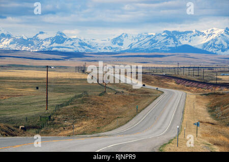 Driving Hiway 2, known as the Hi-Line, in north central Montana looking west to the Rocky Mountains. East of Browning, Montana. Stock Photo