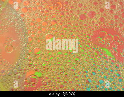 oil bubble floating on water surface in color background Stock Photo