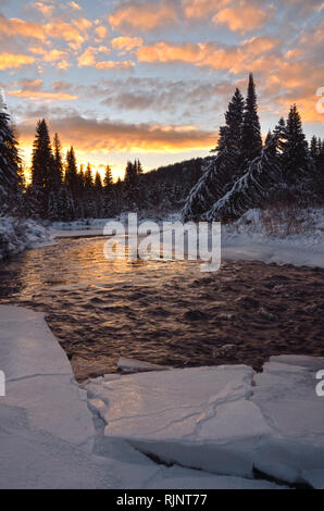 Ice along the Yaak River at sunset in winter. Yaak Valley, northwest Montana. (Photo by Randy Beacham) Stock Photo