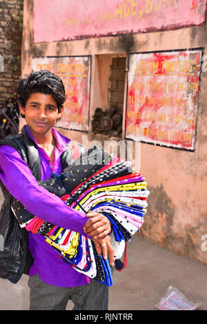 Indian Boy selling textiles, Bundi, Rajasthan, India Stock Photo