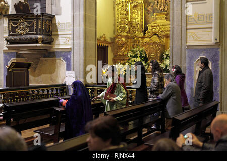 Braga, Portugal - April 1, 2010: People and religious human figures praying and preparing for the night procession of the Ecce Homo during holy week Stock Photo