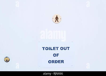 Male toilet broken out of order sign Stock Photo