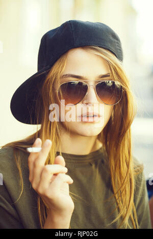 Pretty young girl smoking cigarette Stock Photo