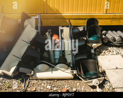 Multiple broken parts of plastic traffic lights in heap on concrete pavement semaphore Stock Photo