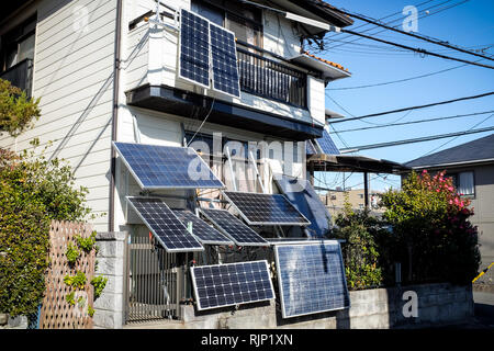 A house in Osaka, Japan, with lots of solar panels attached. It's highly unusual to see panels attached in this way. Stock Photo