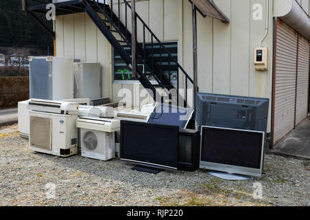 Used electronics, also known as e-waste, on a street in Japan. Stock Photo