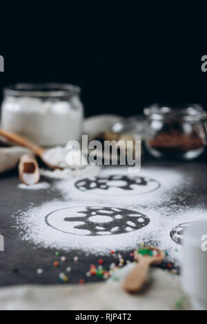Ingredients for donuts baking. Spoon with flour, dishes, eggs, sugar on a grey background. Top view, copy space. Bakery background frame. Stock Photo