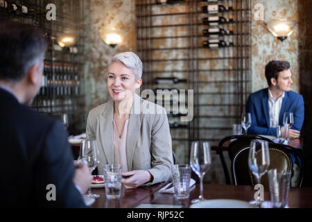 Mature female enjoying a meal in a restaurant Stock Photo