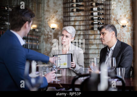 Business executives having a working lunch in a restaurant Stock Photo