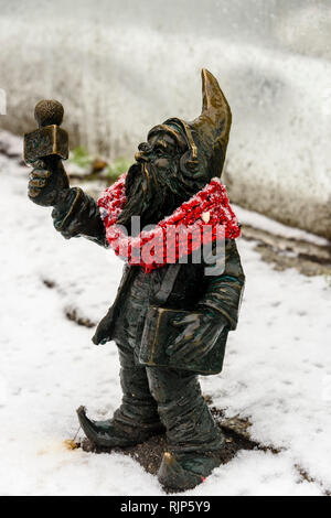 One of the brass gnomes (krasnale, krasnoludki) with a knitted scarf, Wrocław, Wroklaw, Poland Stock Photo