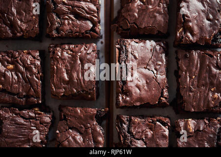 Freshly made chocolate brownies cooling on a bakery table Stock Photo