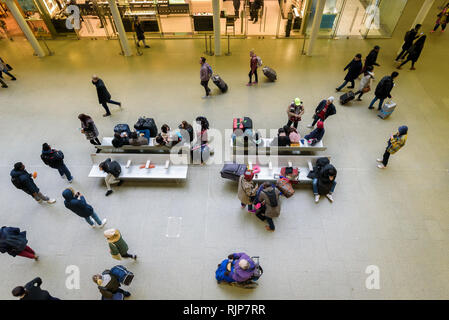 London, England. January 2018. Passengers wait for their trains and running to catch them at St Pancras international train station. Stock Photo