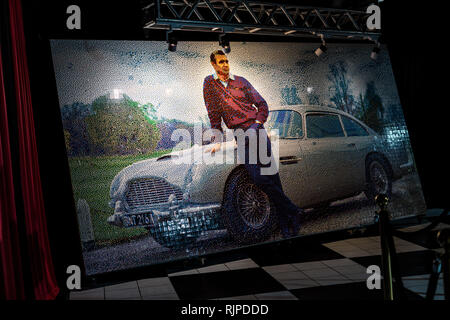 A Lego mosaic of Sean Connery posing with a 1964 Aston Martin DB5 created by Ryan McNaught aka The Brickman Stock Photo