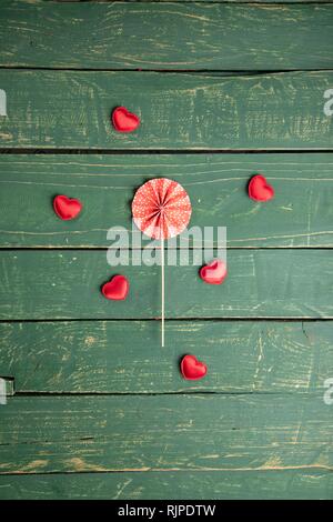 Small hearts on green background Stock Photo