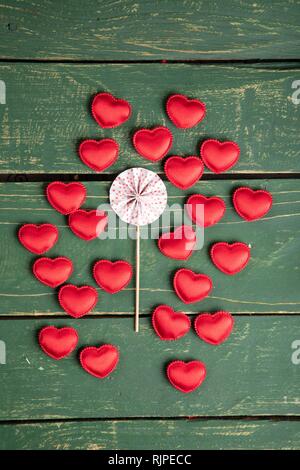 Small hearts on green background Stock Photo