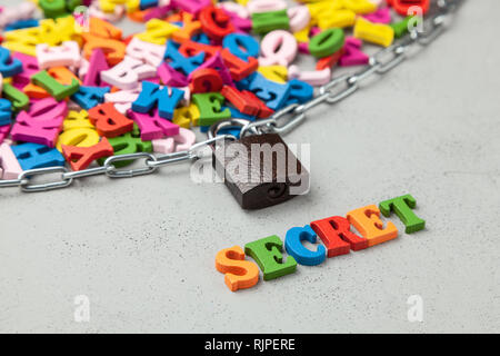 Secret Information. Letters of information symbol wrapped in chain and locked. Stock Photo