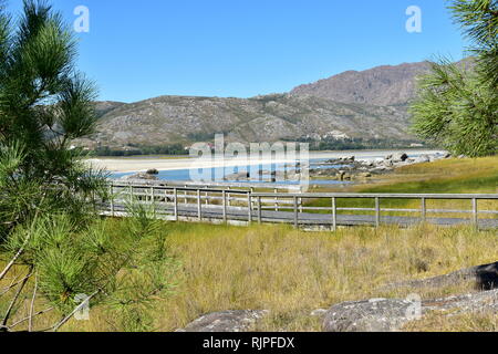 Boardwalk To Beach With Bright Sun And Blue Sky Stock Photo