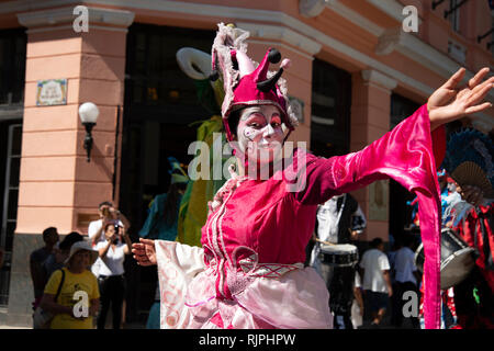 A female street entertainer dressed in costume performs for the crowds in Havana Cuba Stock Photo