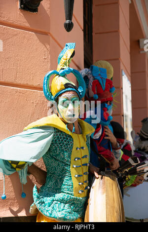 Two street theatre musicians with painted faces and wild circus costumes entertain on the streets of Havana Vieja Cuba Stock Photo