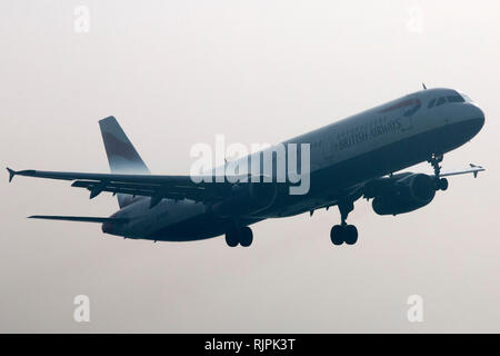 An aircraft lands at London Heathrow airport in heavy fog on March 13, 2014. Stock Photo