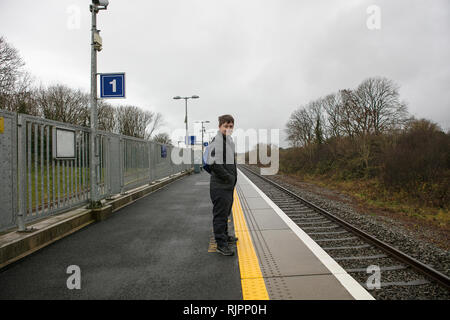 Man with down syndrome on platform in train station, Galway, Ireland Stock Photo
