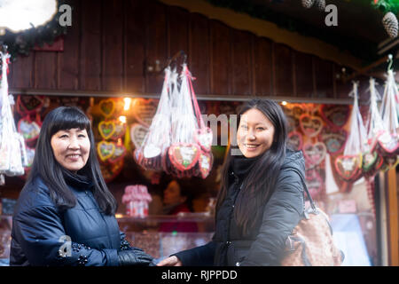Mother and daughter window shopping at Christmas market, Freiburg, Baden-Wurttemberg, Germany Stock Photo