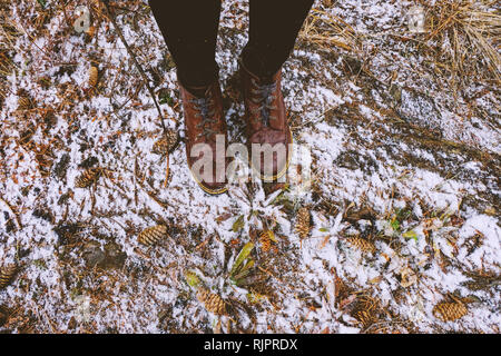 Feet of woman standing in forest in winter, Ural, Sverdlovsk, Russia Stock Photo