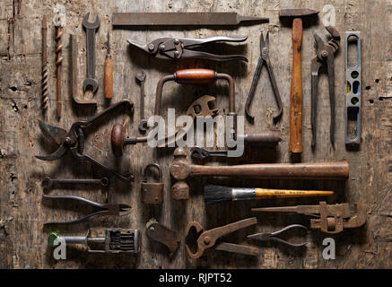 Variety of vintage hand tools on wood, overhead view Stock Photo