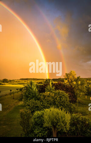 Rainbow over rural landscape Stock Photo - Alamy