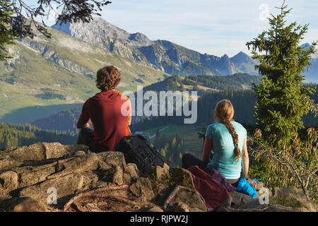 Hikers enjoying view of mountains, Manigod, Rhone-Alpes, France Stock Photo