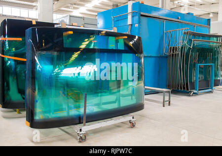 Tempered bus glass products in tempered glass factory. Tempering industry. Stock Photo