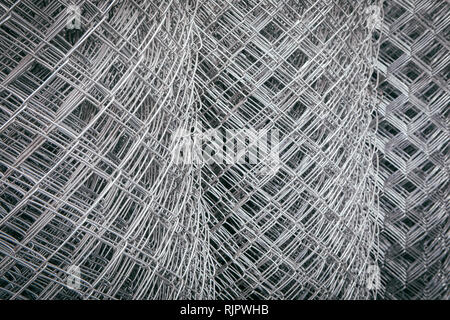 Steel or iron wire mesh fence rolls coils. Construction or building background. Stock Photo