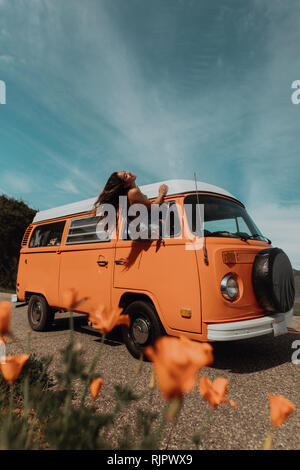 Young woman sitting out through recreational vehicle window,   Jalama, California, USA Stock Photo