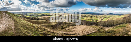 Panorama view from the summit of Painswick Beacon in the Cotswolds, Goucestershire, UK. Standing on the hill fort looking out across the plain of the  Stock Photo