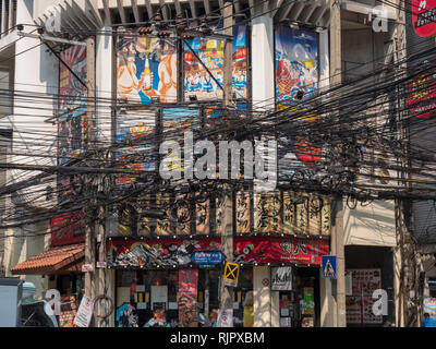 A confusing web of electricity wires and cables  hung across a city street in Bangkok Thailand Stock Photo