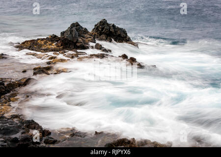 Rough seas swirling around rocks on the east coast of Tenerife, Canary Islands, Spain Stock Photo