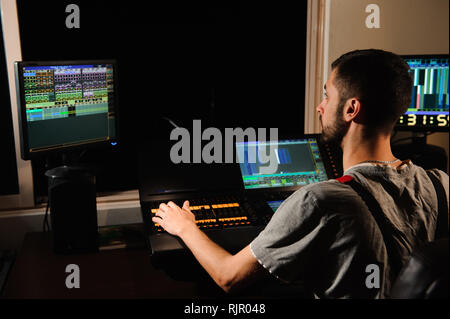 A lighting engineer works with lights technicians control Stock Photo