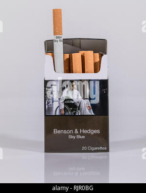 An open packet of Benson & Hedges Sky Blue cigarettes in plain packaging on  a white background Stock Photo