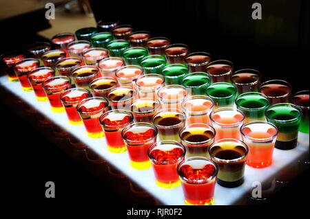 Variation of hard alcoholic shots served on bar counter. Stock Photo