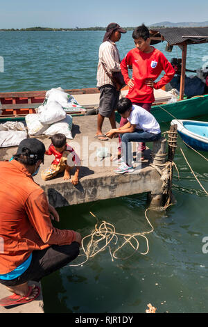 Cambodia, Preah Koh Kong, Prek Kaoh Pao river, Dong Tung Port, boy fishing from jetty Stock Photo