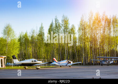 Light passenger planes parked before departure at private airport in Kronshtadt, St.Petersburg Russia. Industrial and civil air transportation by aircraft. Professional flights on airplanes Stock Photo