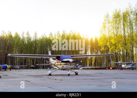 Light passenger planes parked before departure at private airport in Kronshtadt, St.Petersburg Russia. Industrial and civil air transportation by aircraft. Professional flights on airplanes Stock Photo