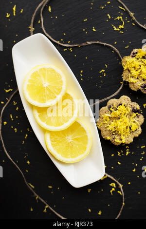 lemon cupcakes on a black background with lemon zest Stock Photo