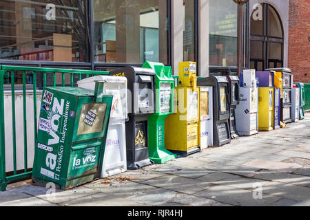 ASHEVILLE, NC, US-2/3/19: A line of vending machines for newspapers and other literature on the sidewalk in front of the city library. Stock Photo