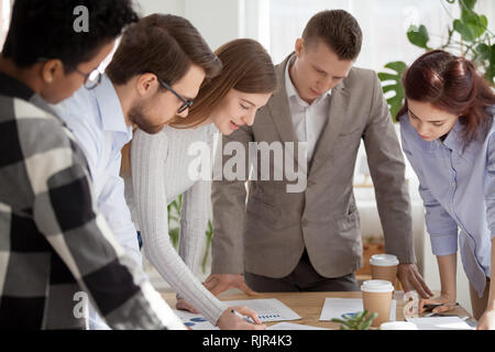 Diverse team people working together brainstorming discussing new business plan Stock Photo