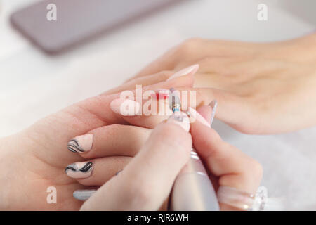 Nail women polish removal with manicure machine Stock Photo