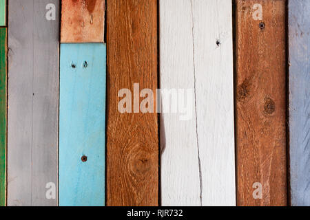 Background from the old boards painted with colorful paints. New use of old items Stock Photo