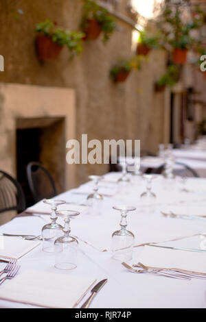 Beautifully laid table in a quiet cozy street of the city. Italy, Calabria, Tropea Stock Photo