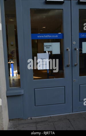 Automatic door with push to open sign taped on it I suppose the door is broken. Stock Photo