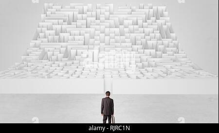 Businessman standing and thinking in front of a curved infinity maze  Stock Photo